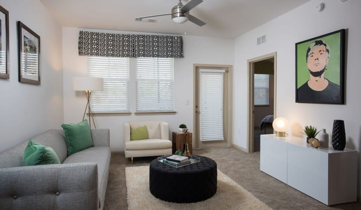 A furnished apartment living room with a ceiling fan at Village at Rice Hope in Port Wentworth, Georgia
