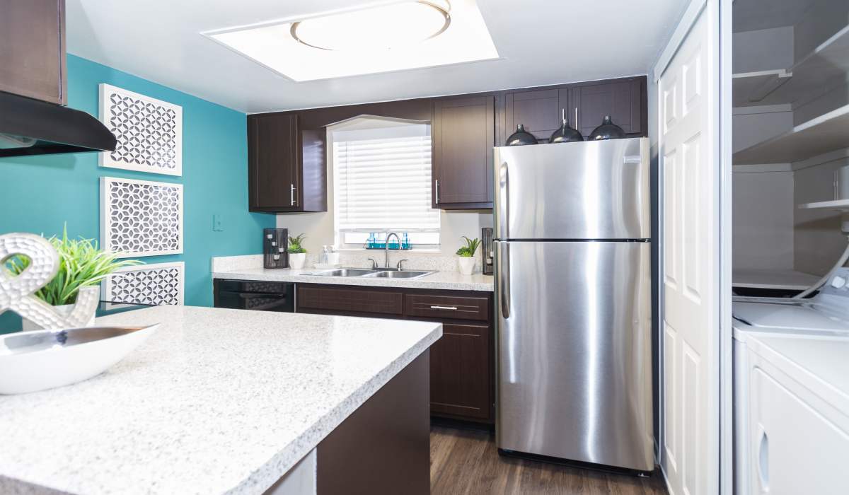 Apartment kitchen with stainless-steel fridge at Central Place at Winter Park in Winter Park, Florida