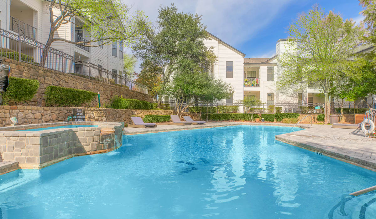Take a dip in our shimmering swimming pool at Devi at Valley Ranch in Irving, Texas