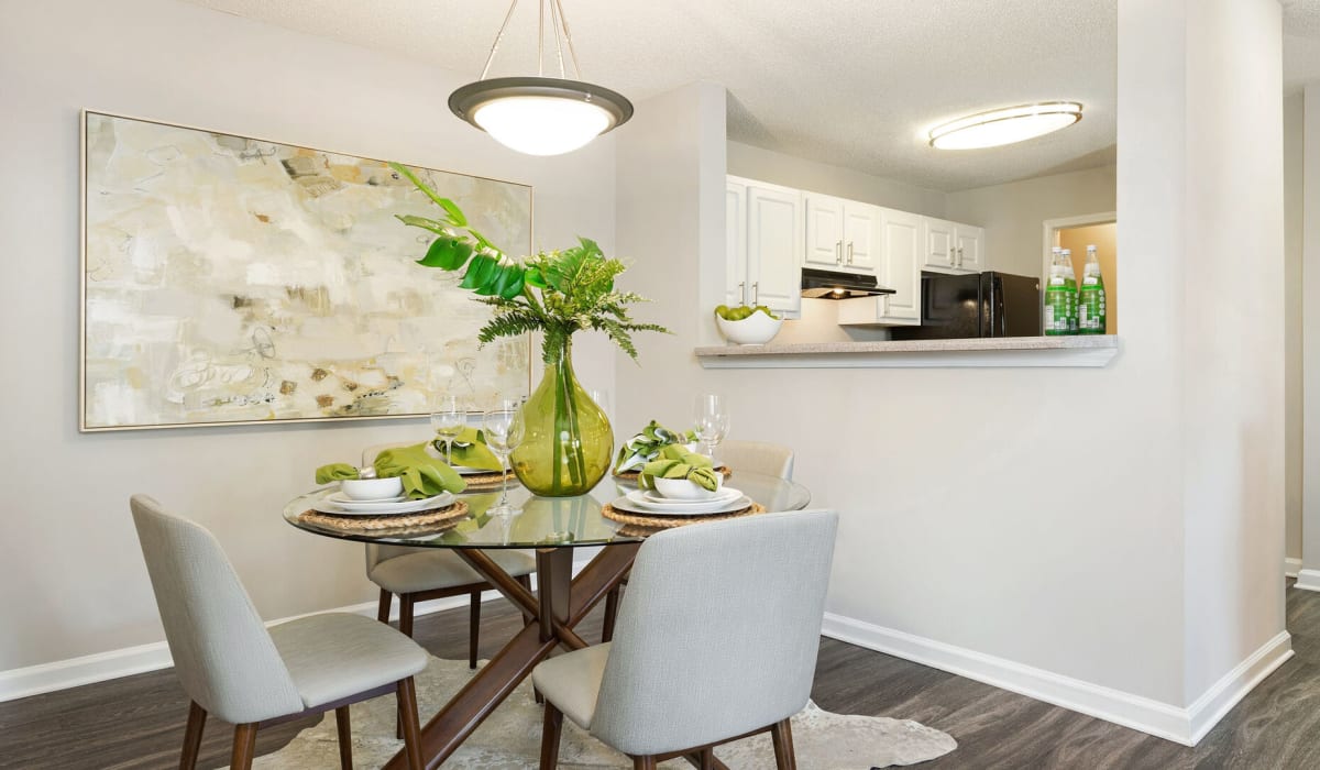 Dining area with kitchen at Belle Vista Apartments in Lithonia, Georgia