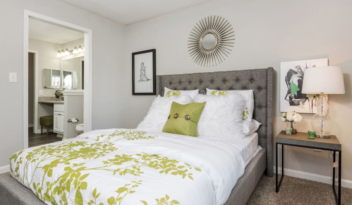 Bedroom with green pillows at Belle Vista Apartments in Lithonia, Georgia