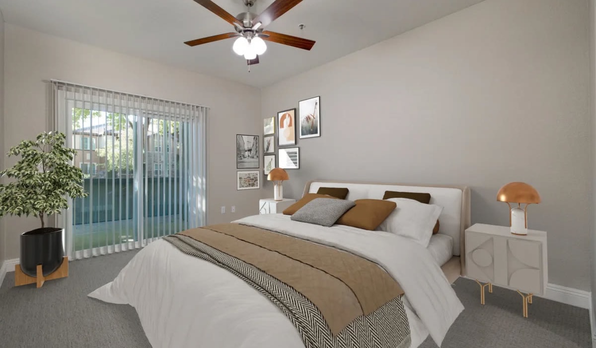 Model bedroom opening onto a private balcony at The Preserve at Creekside in Roseville, California