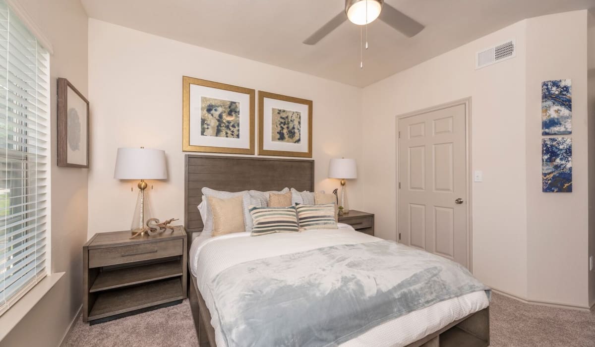 Bedroom with cozy blanket at Sheffield Square in Grand Prairie, Texas