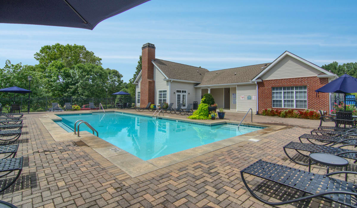 Exterior and outdoor pool at Villas by the Lake in Jonesboro, Georgia