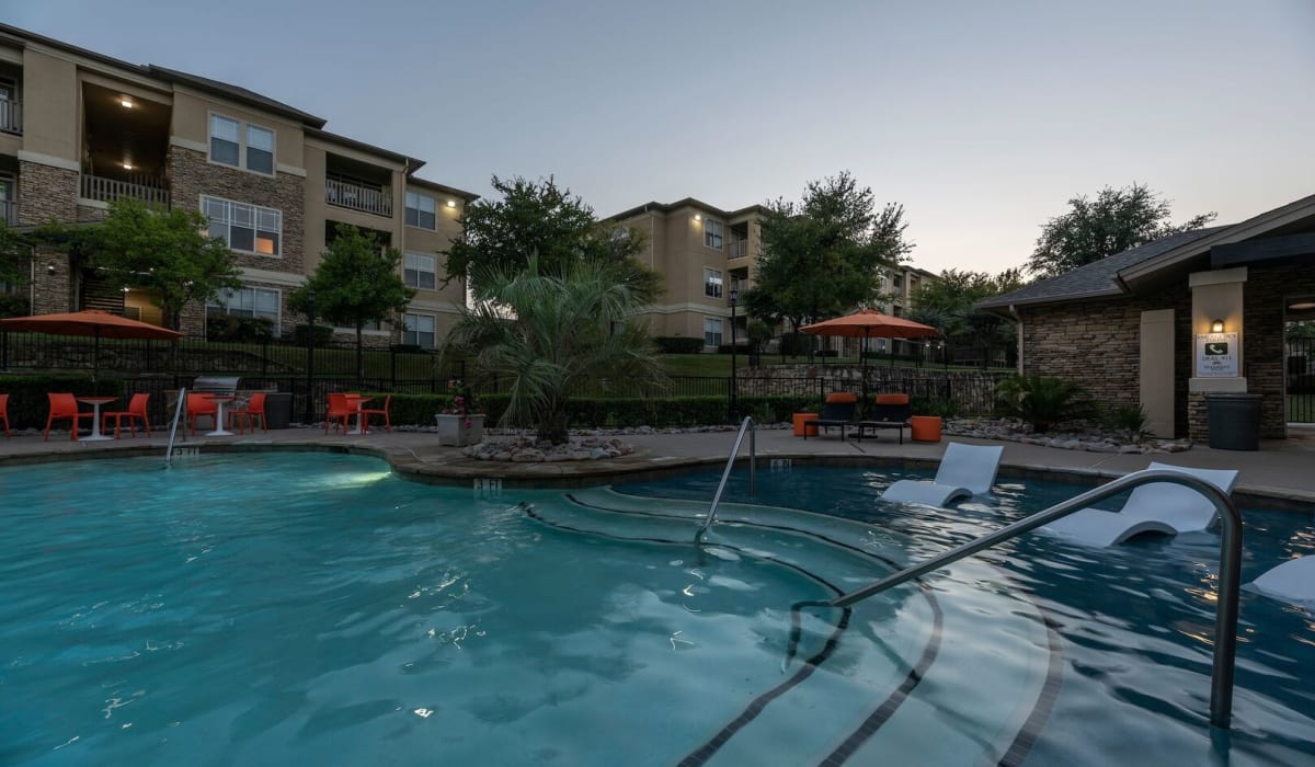 Pool at dusk at Woodbridge Villas Apartments in Sachse, Texas