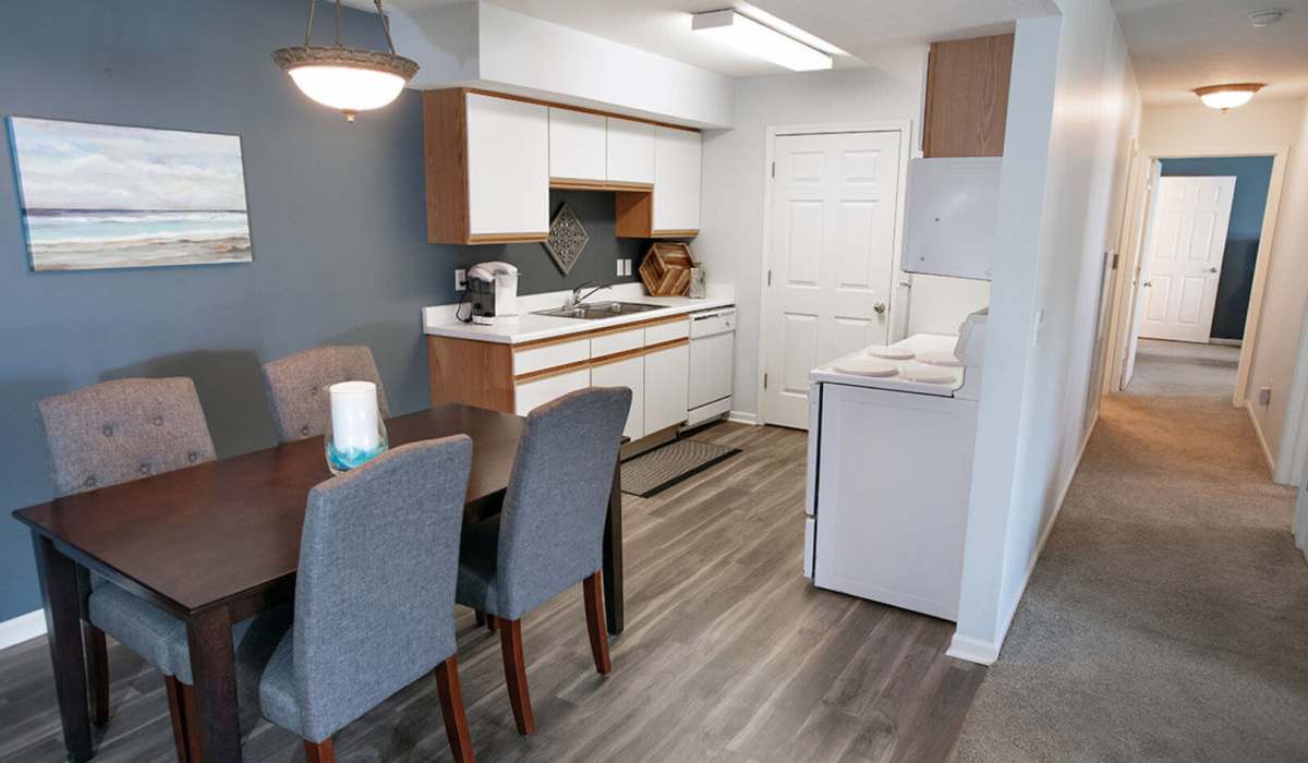 Resident couple chatting on the bed in their new luxury home at Hamptons of Norton Shores in Norton Shores, Michigan