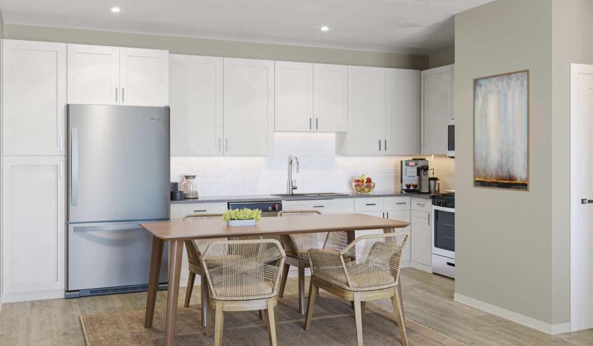 Luxury Townhomes In Folsom Ranch, CA - Kitchen With Shaker-Style Cabinetry, Quartz Countertops, Stainless-Steel Appliances, Dishwashers, Wood-Style Plank Flooring, And A Built-In Microwave.
