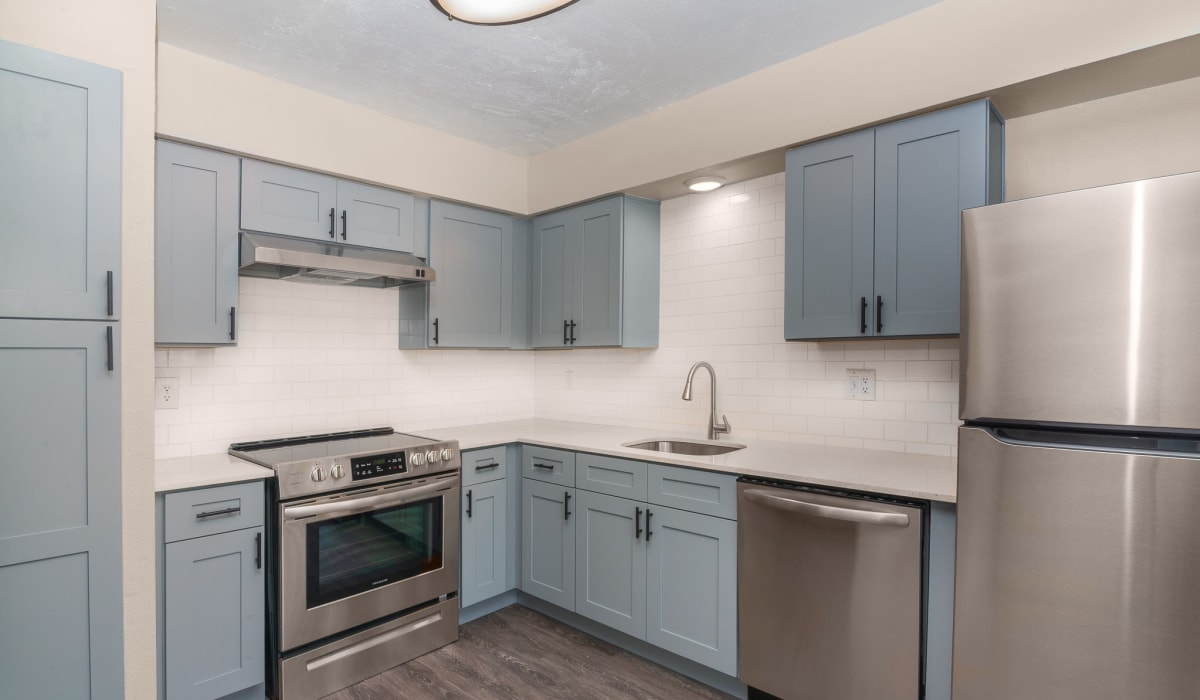 Renovated kitchen with stainless steel appliances at  Barrett Apartment Homes in Garland, Texas