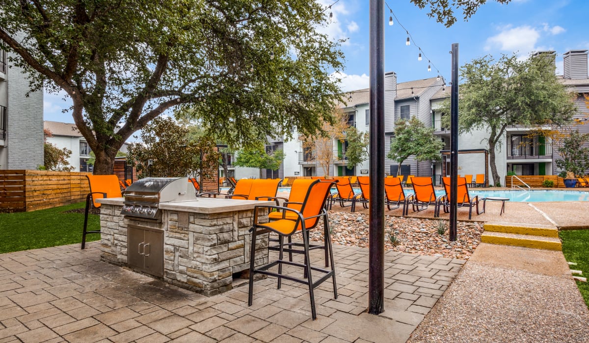 BBQ area near the pool at Birch Apartment Homes in Dallas, Texas