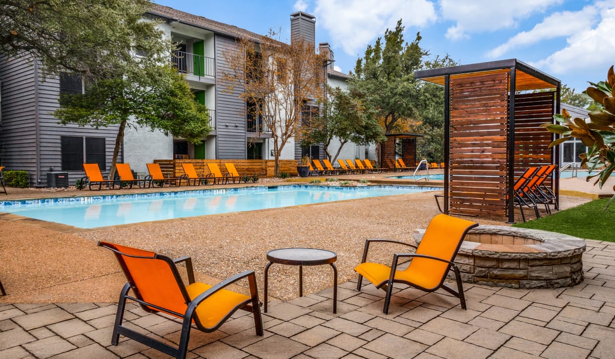 Pool with nice seating at Birch Apartment Homes in Dallas, Texas