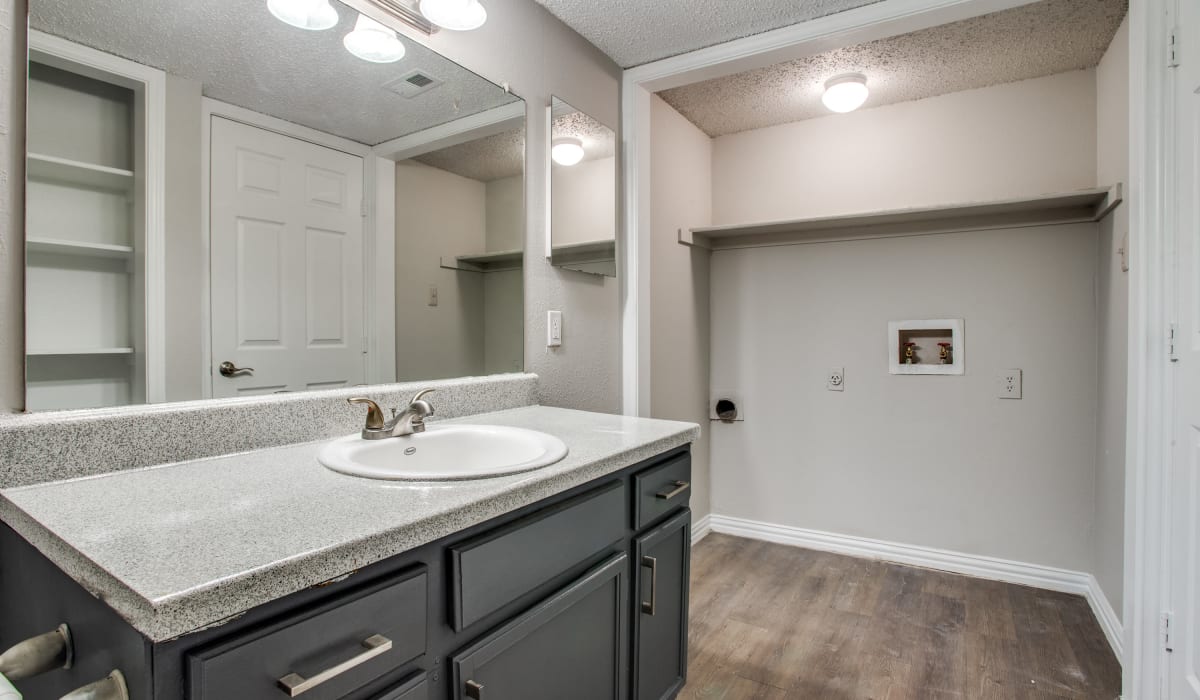 Bathroom with laundry hookups at Decker Apartment Homes in Ft Worth, Texas