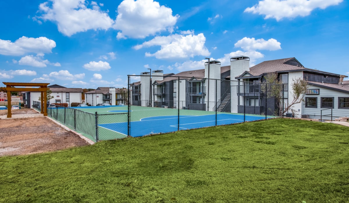 Tennis courts next to grass at Decker Apartment Homes in Ft Worth, Texas