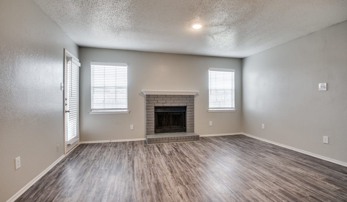 Living room with fireplace at Hawke Apartment Homes in Irving, Texas