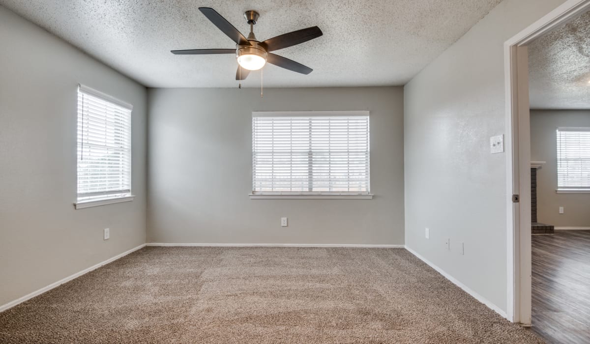 Living room with ceiling fan at Hawke Apartment Homes in Irving, Texas