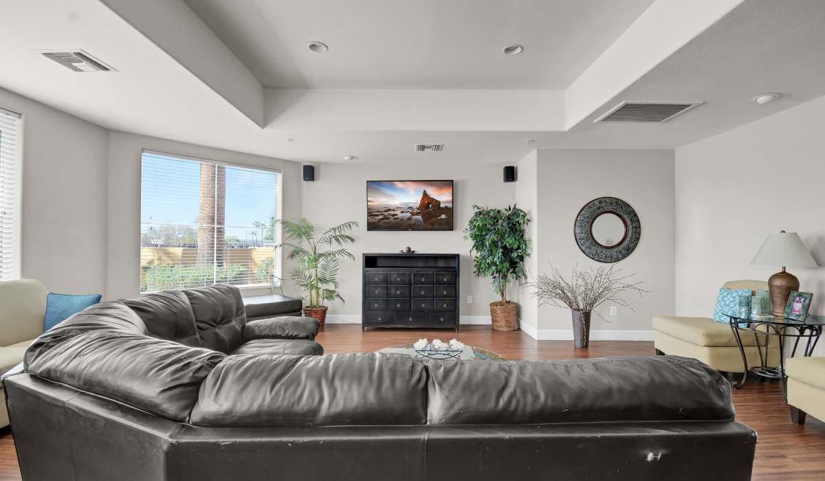 Model home with a leather couch at La Serena at Toscana in Phoenix, Arizona