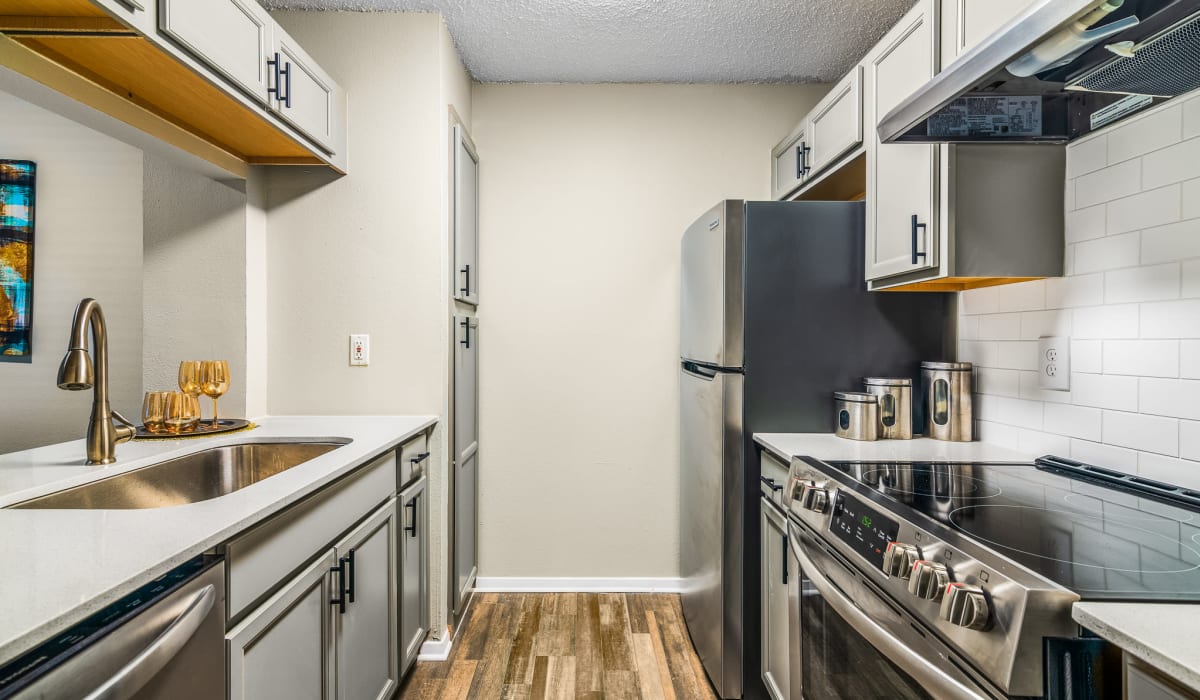 Modern Kitchen Featuring Stainless Steel Appliances at Holbrook Apartment Homes in Dallas, Texas