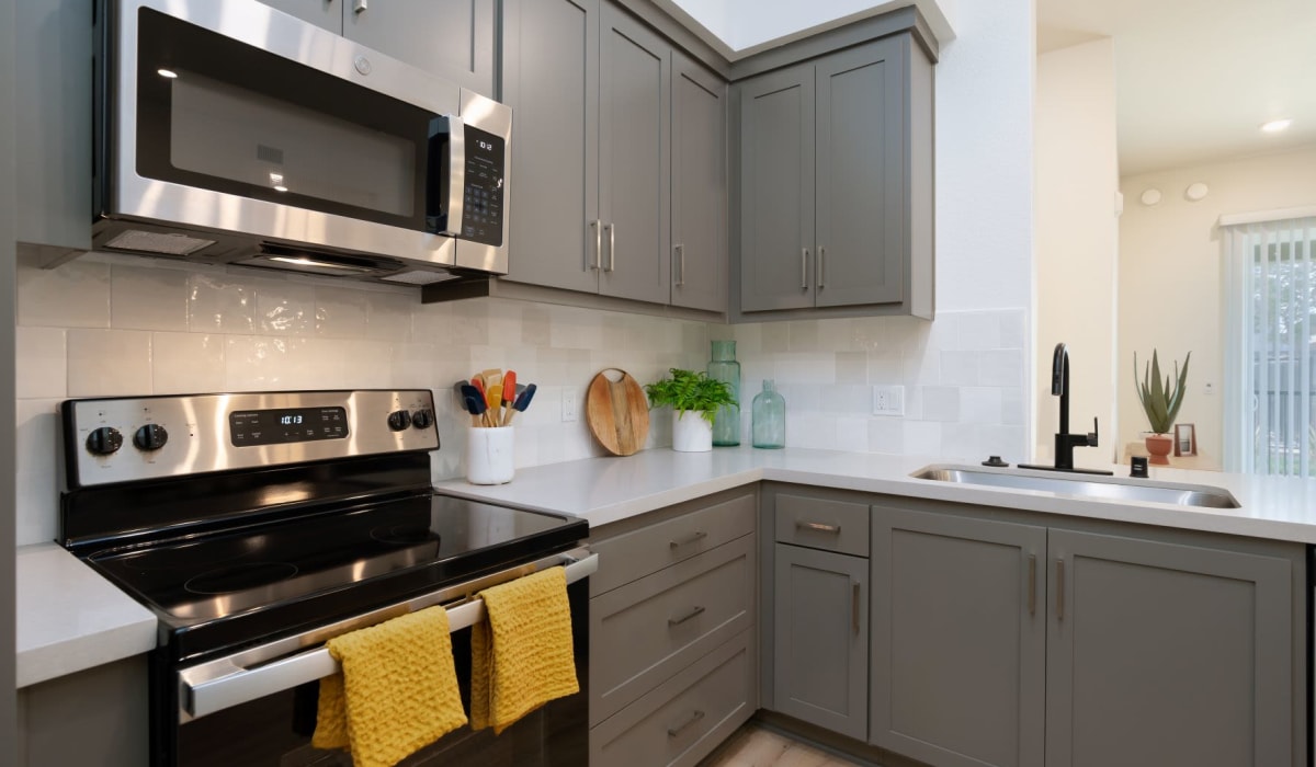 Kitchen with stainless-steel appliances at Towne Centre Apartments in Lathrop, California
