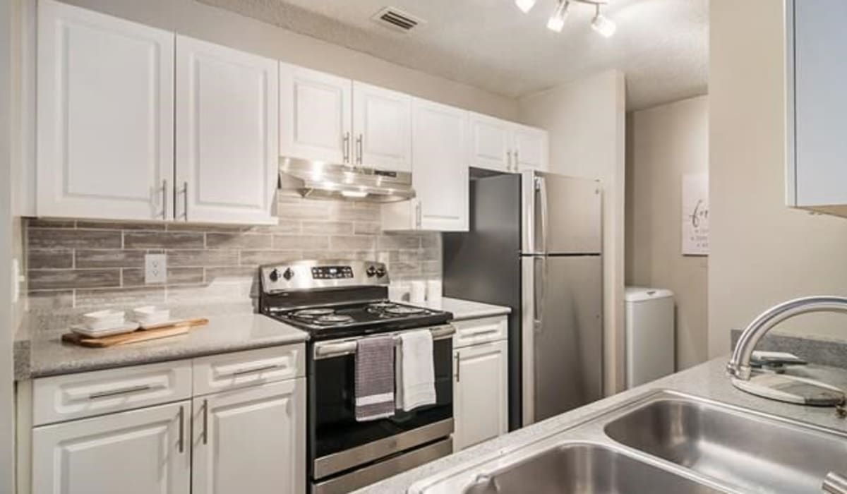 An apartment kitchen with a backsplash at Ten68 West in Dallas, Georgia