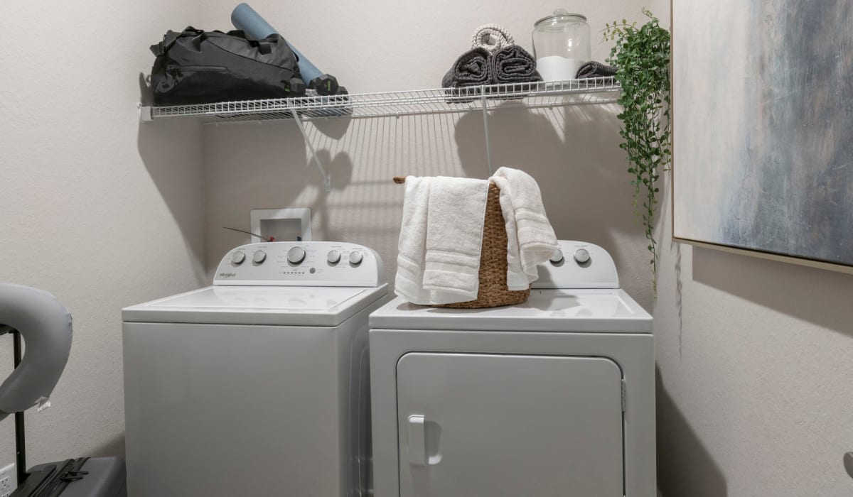 A full-sized washer and dryer in an apartment laundry room at Sentosa Riverview in Riverview, Florida