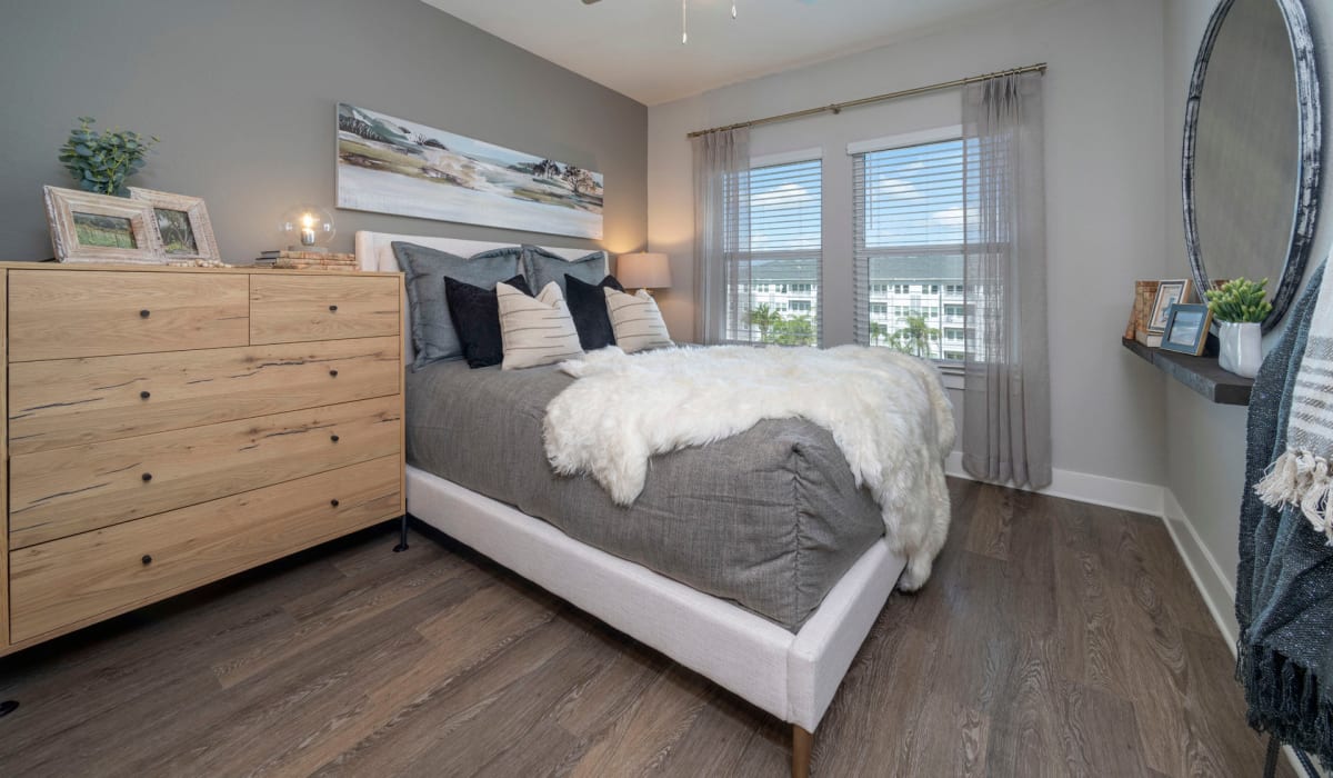 Wood flooring in a furnished apartment bedroom at Sentosa Riverview in Riverview, Florida