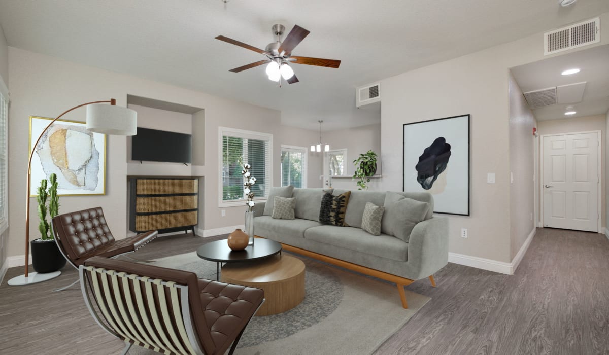Spacious model living room with a ceiling fan and vinyl plank flooring at The Preserve at Creekside in Roseville, California