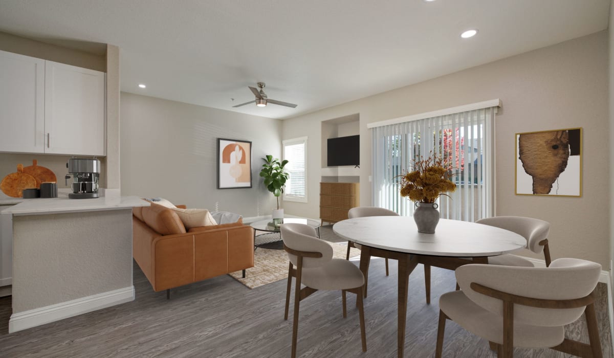 Dining area and living room of a model apartment with wood-style plank flooring at The Preserve at Creekside in Roseville, California