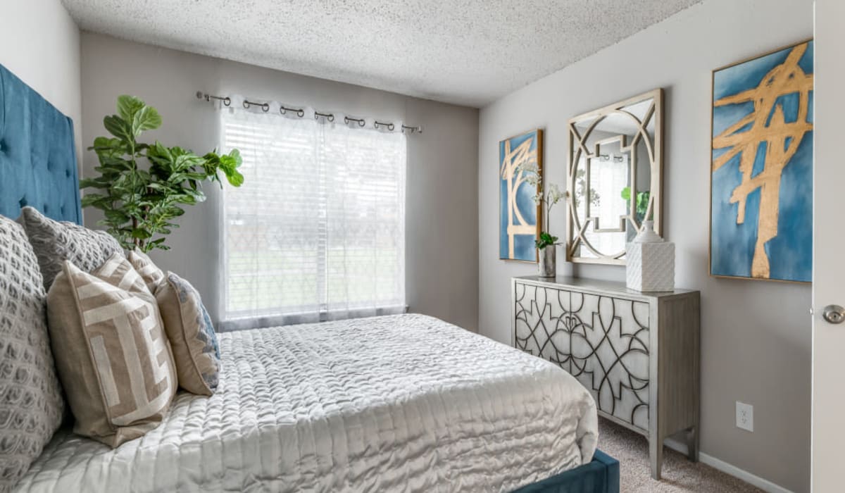 Bedroom with large window at  Emmitt Luxury Apartments in Haltom City, Texas