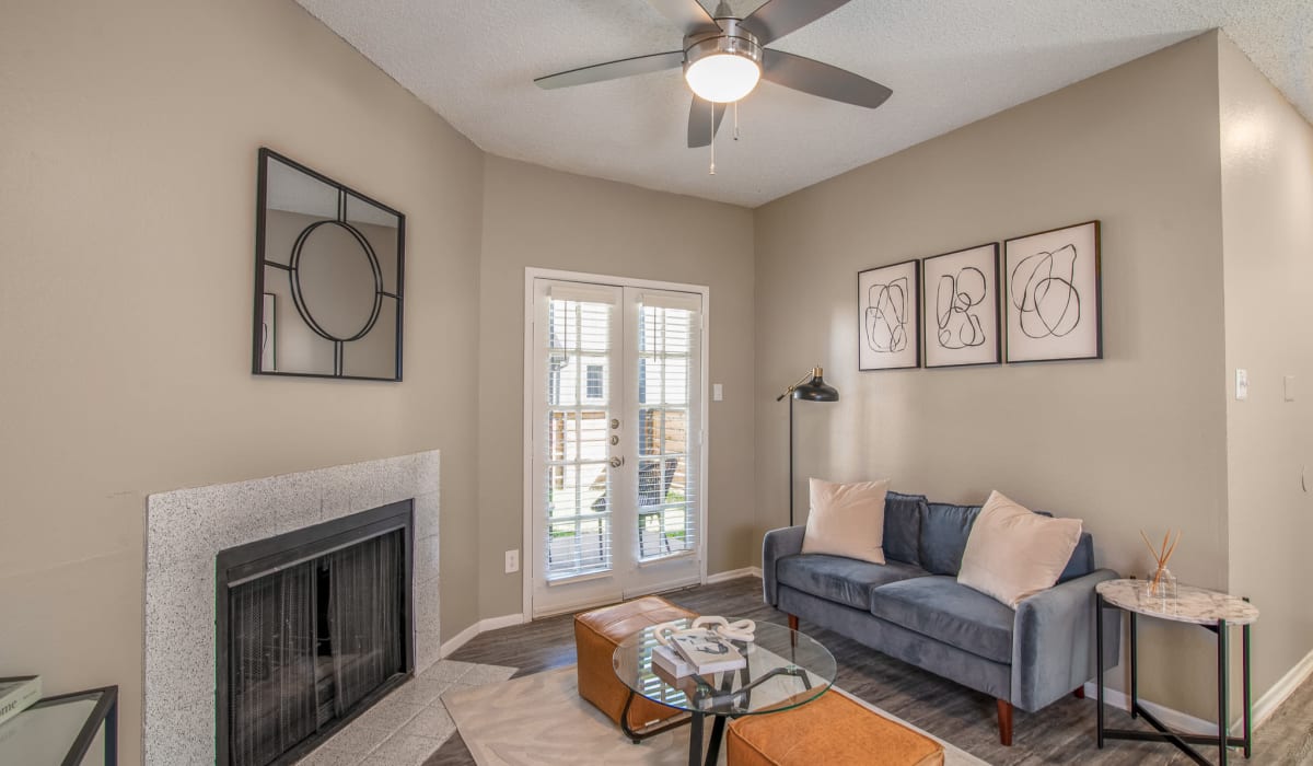 Living room with a fireplace at Knowlton Apartment Homes in Mesquite, Texas