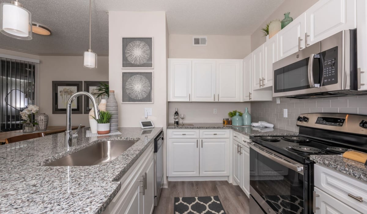 Kitchen with island at Gardens of Valley Ranch in Irving, Texas