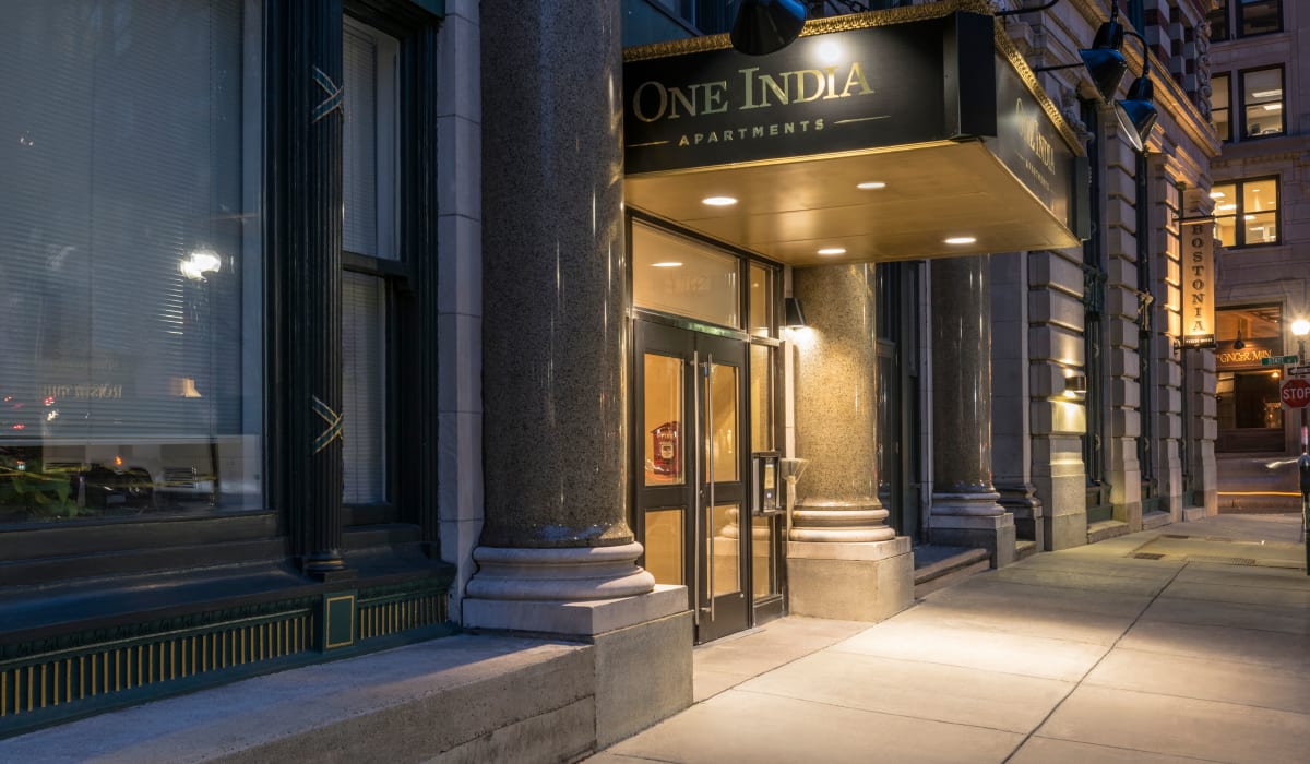 Exterior and main entrance at dusk at One India Street Apartments in Boston, Massachusetts