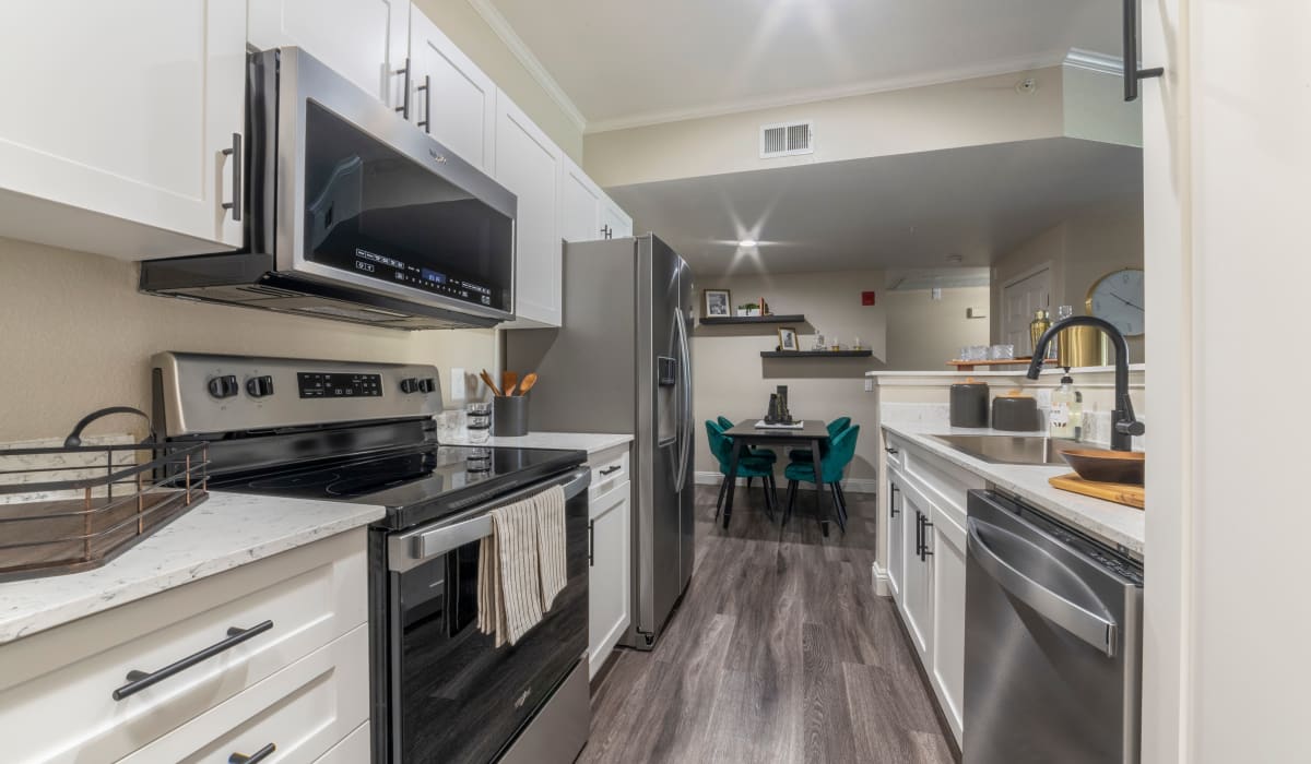 Kitchen with stainless-steel appliances at Cobble Oaks Apartments in Gold River, California