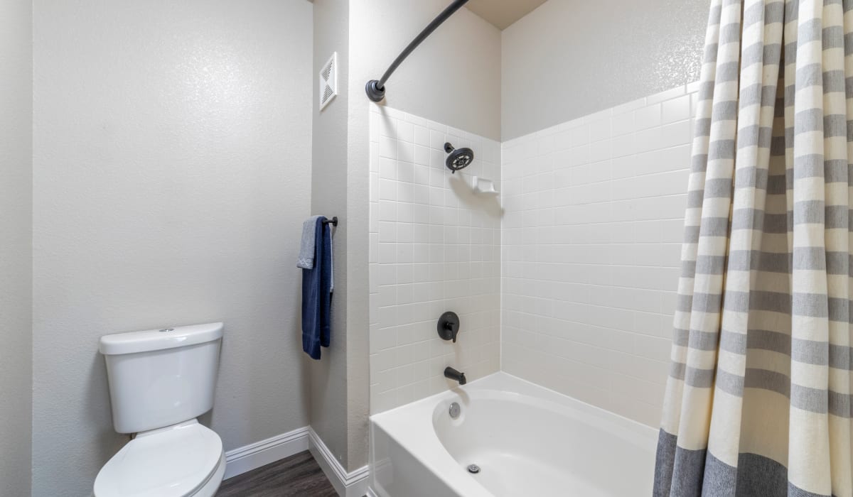 Bathroom with tub at Cobble Oaks Apartments in Gold River, California