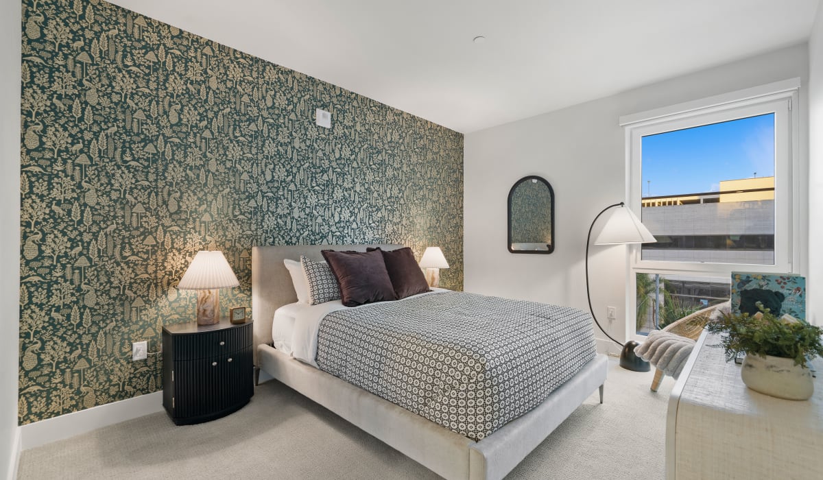 Bedroom with green wallpaper at Aster in Long Beach, California 