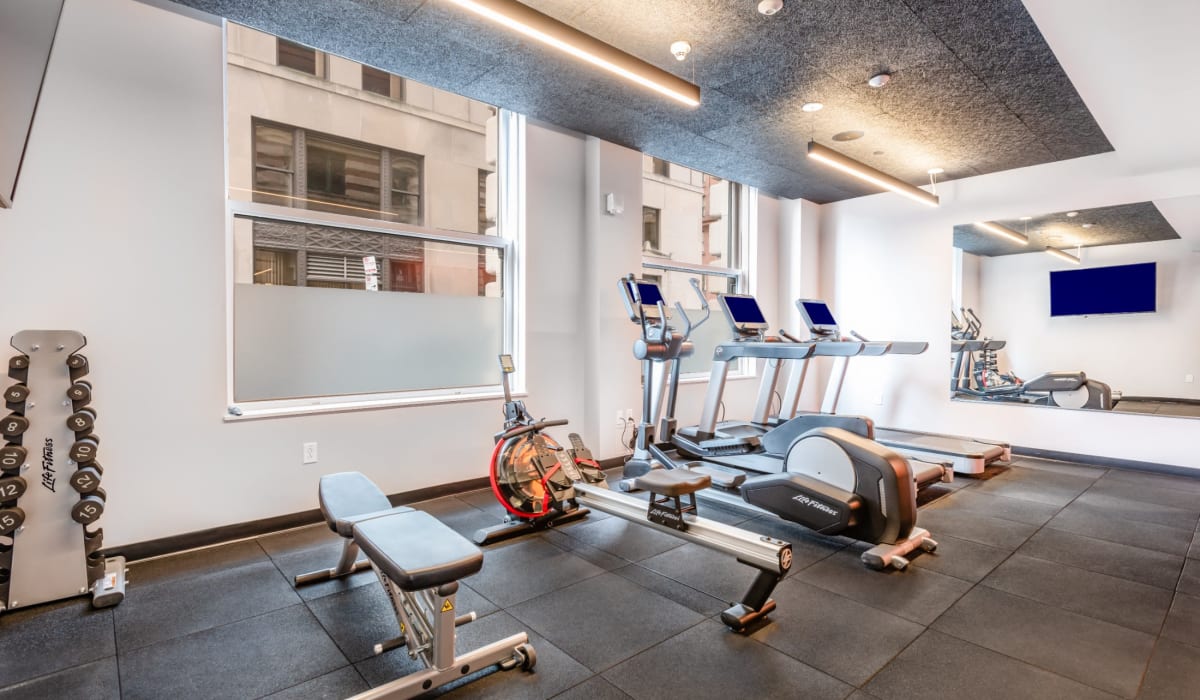 Community fitness center with free weights and treadmills at One India Street Apartments in Boston, Massachusetts