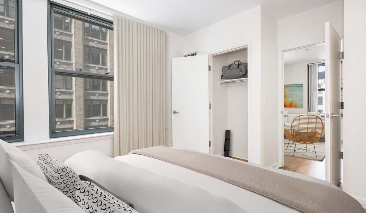 Apartment bedroom with closet and city views at One India Street Apartments in Boston, Massachusetts