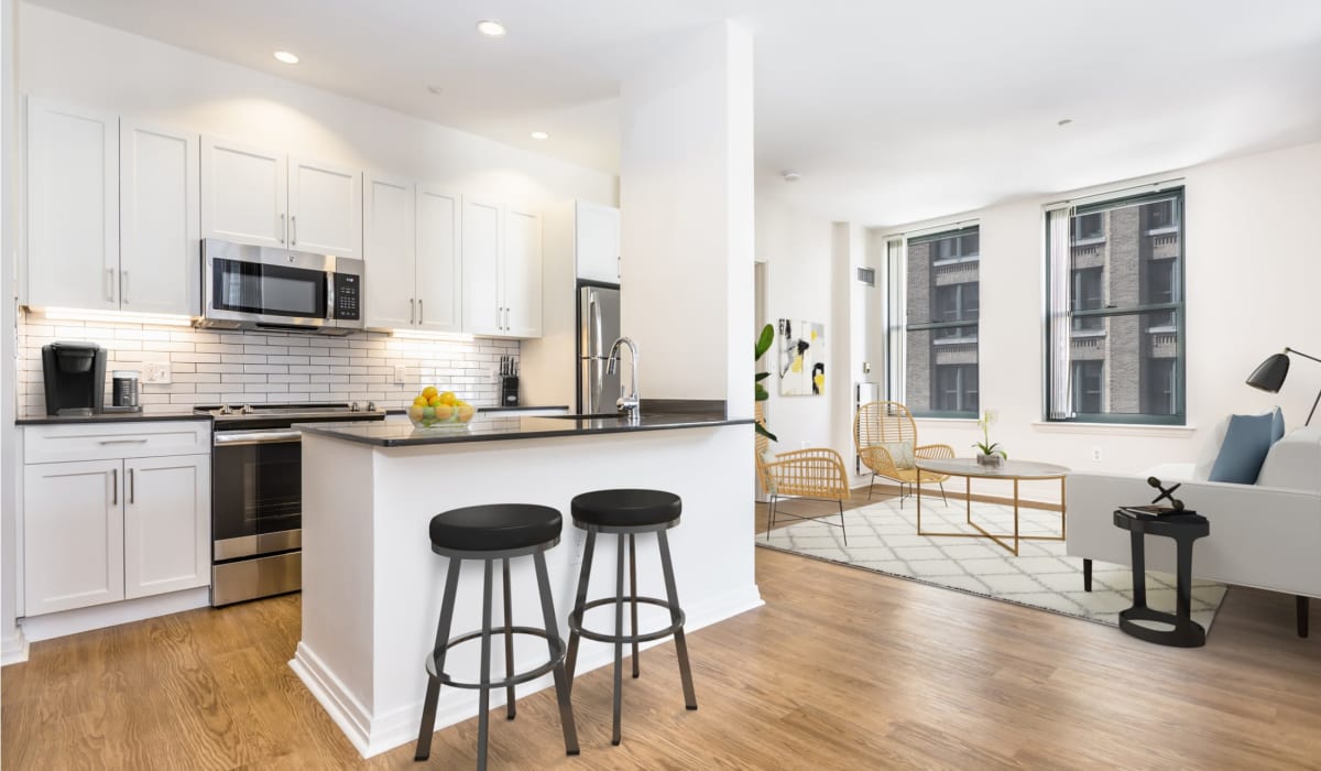 Open concept floor plan with hardwood floors and eat-in kitchen at One India Street Apartments in Boston, Massachusetts