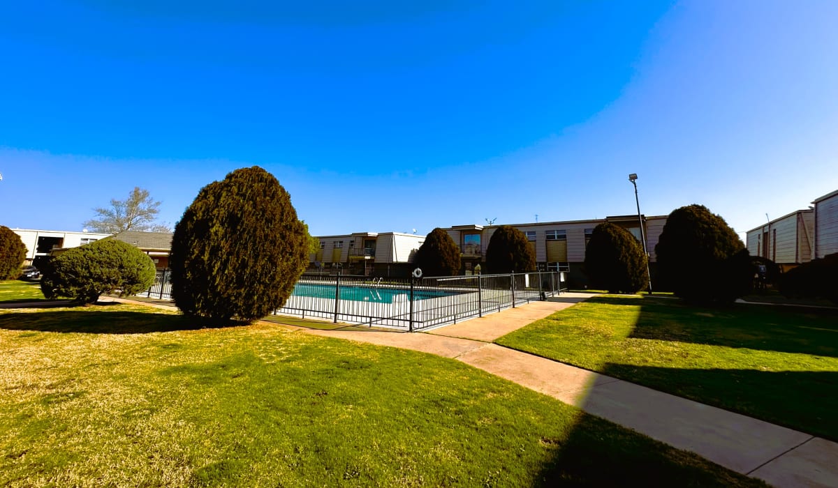 Pool and grassy area of Regency Apartments in Lawton, Oklahoma