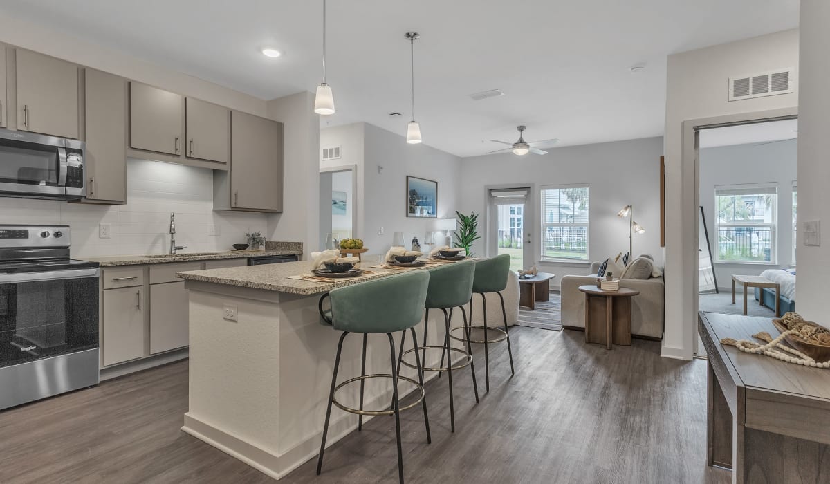 An apartment kitchen with and island and bar seating at Avocet at Melbourne in Melbourne, Florida