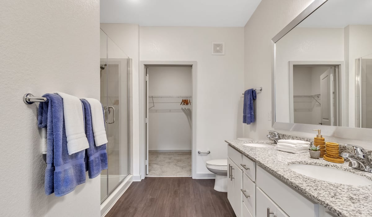 A large bathroom with a double vanity and walk-in closet at Avocet at Melbourne in Melbourne, Florida