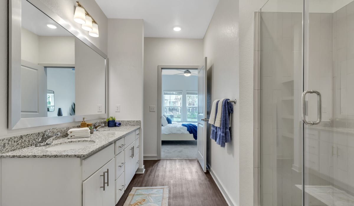 A double vanity and walk-in shower in a main bedroom at Avocet at Melbourne in Melbourne, Florida