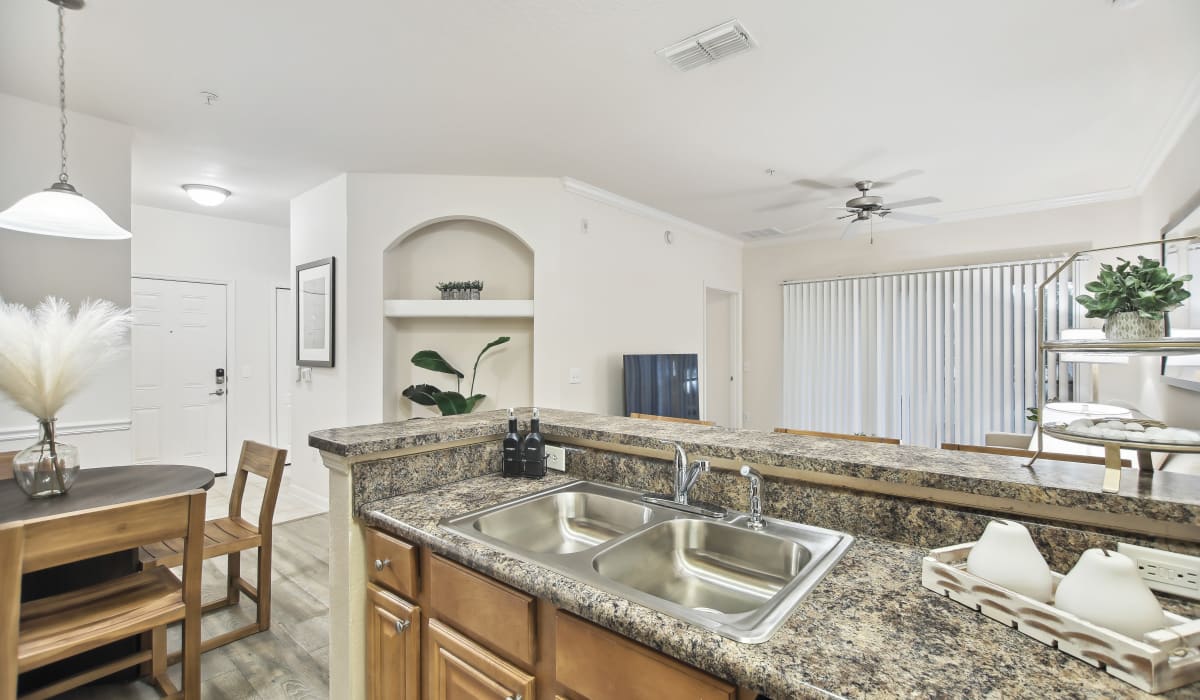 Kitchen view of the living area at Heritage on Millenia Apartments in Orlando, Florida