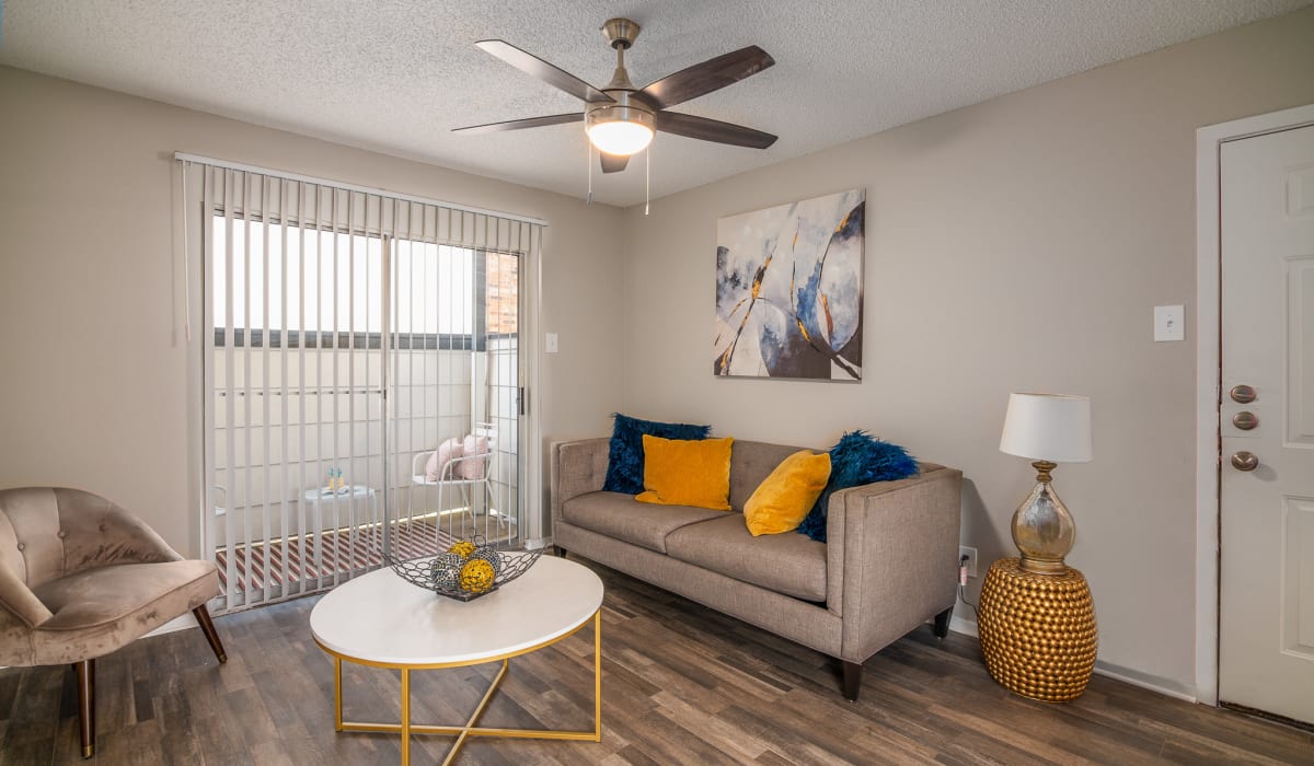 Stylish Living Room With Grey Sofa and Accent Chair at Holbrook Apartment Homes in Dallas, Texas