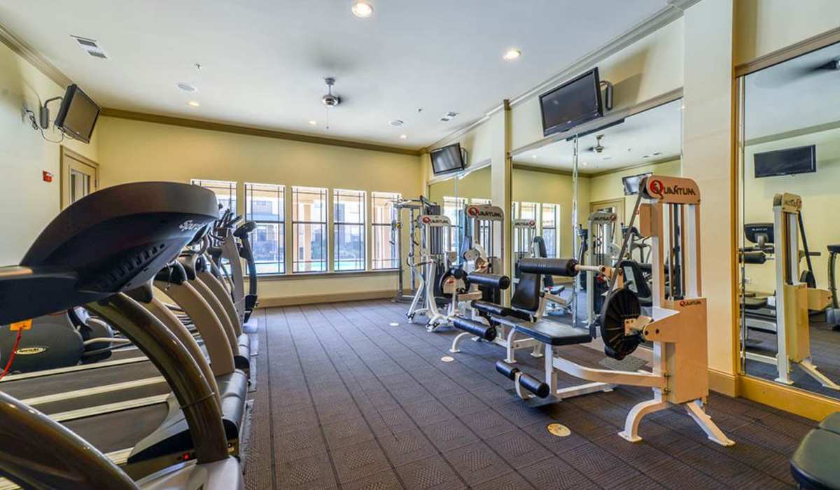 Fitness center with treadmills at The Reserve at Johns Creek Walk in Johns Creek, Georgia