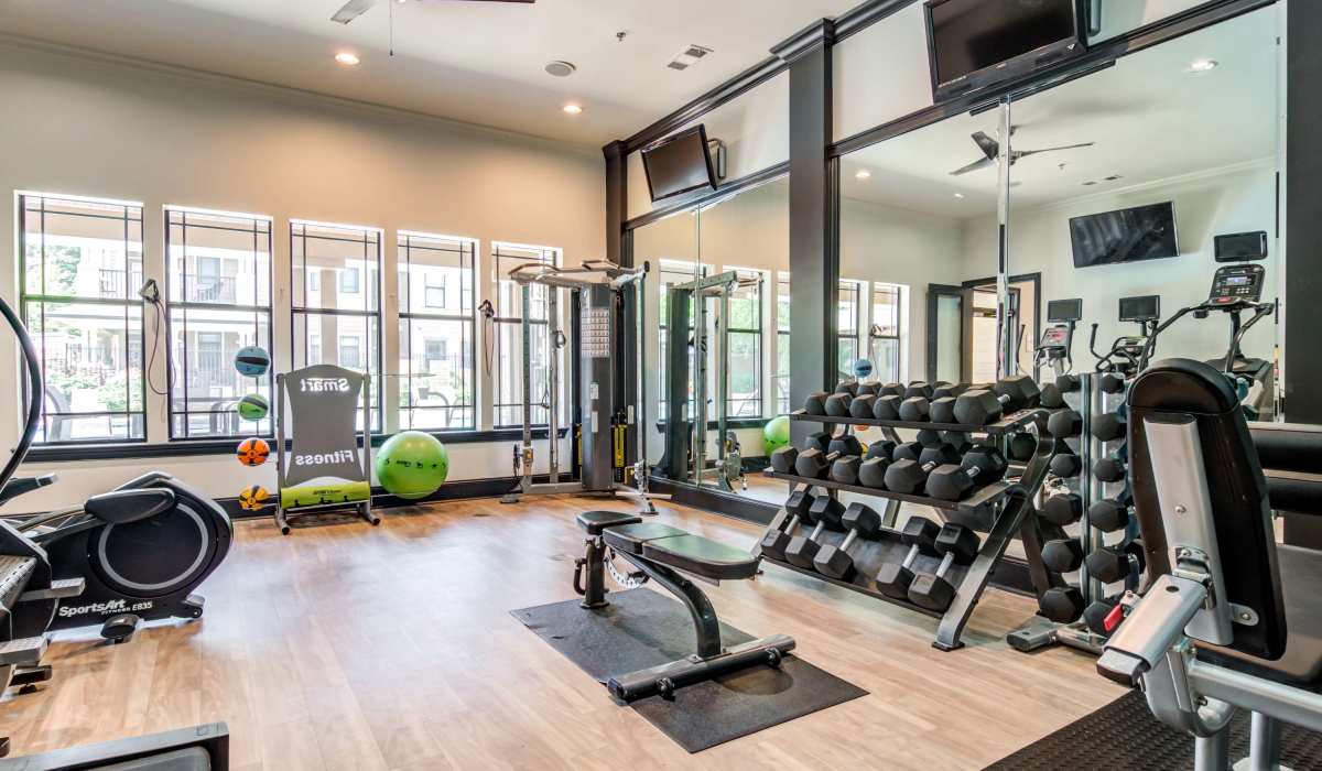 Fitness center with free weights at The Reserve at Johns Creek Walk in Johns Creek, Georgia