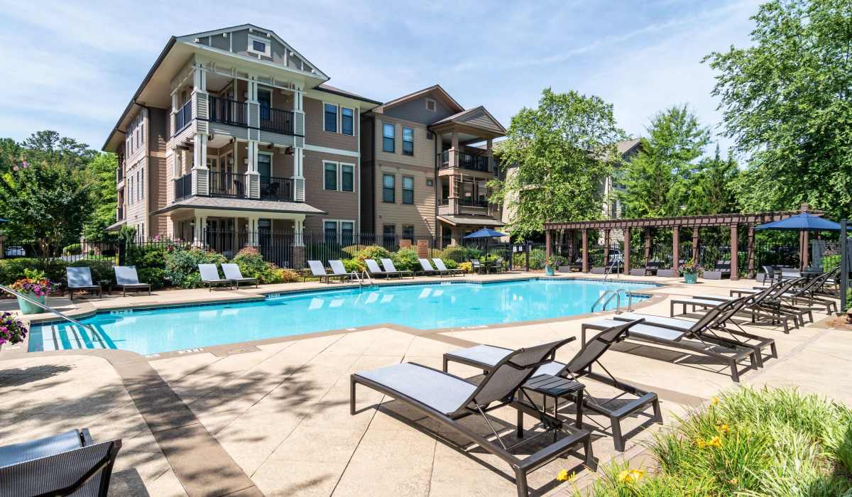 Swimming pool with lounge seating at The Reserve at Johns Creek Walk in Johns Creek, Georgia