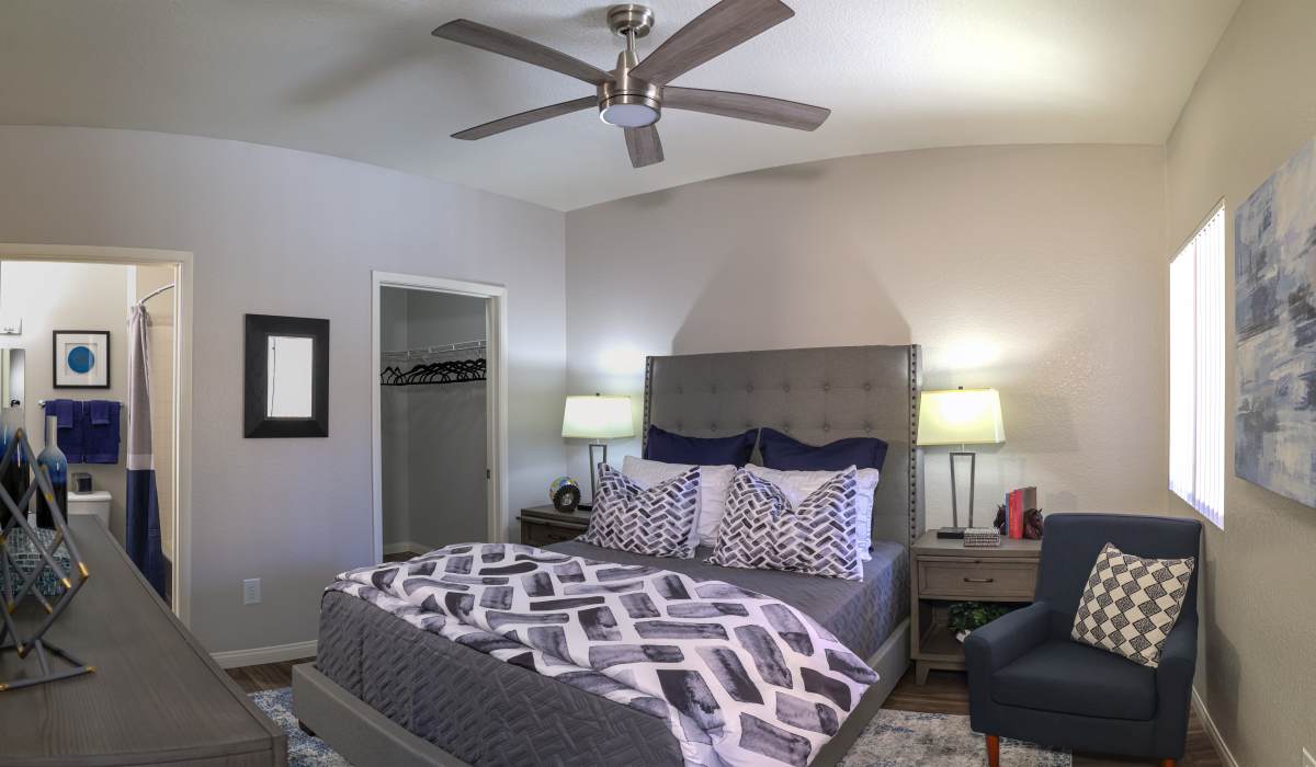 Model bedroom with a fan at La Serena at the Heights in Henderson, Nevada