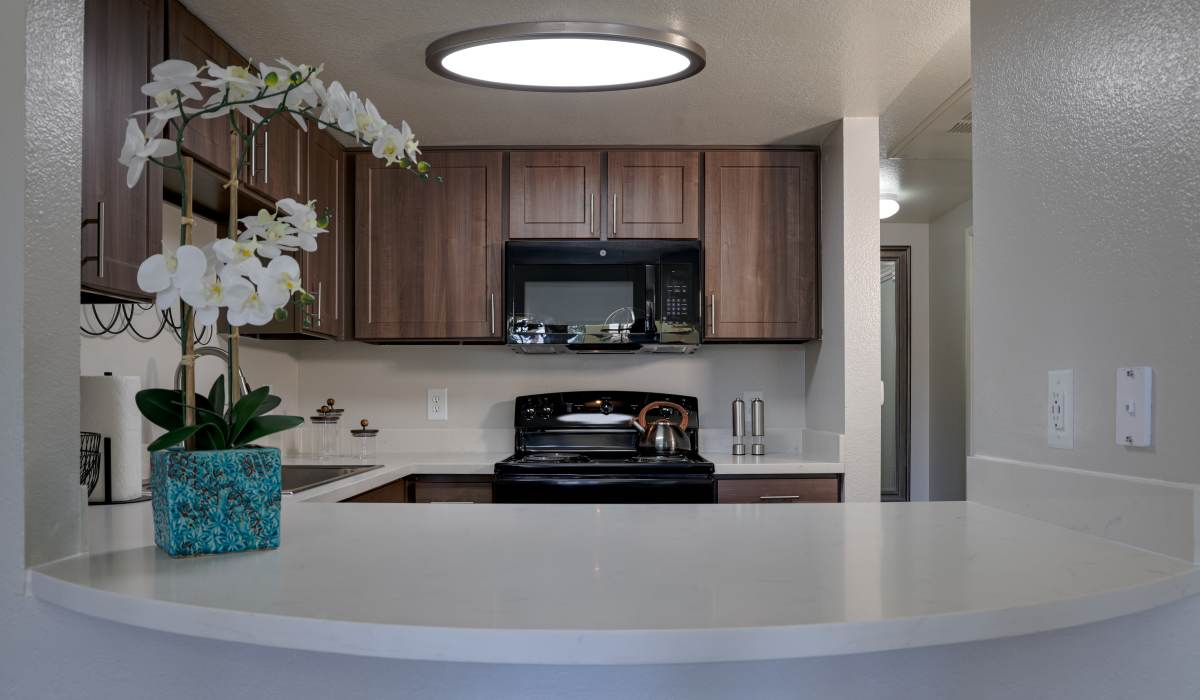 Modern kitchen with a white counter at La Serena at the Heights in Henderson, Nevada