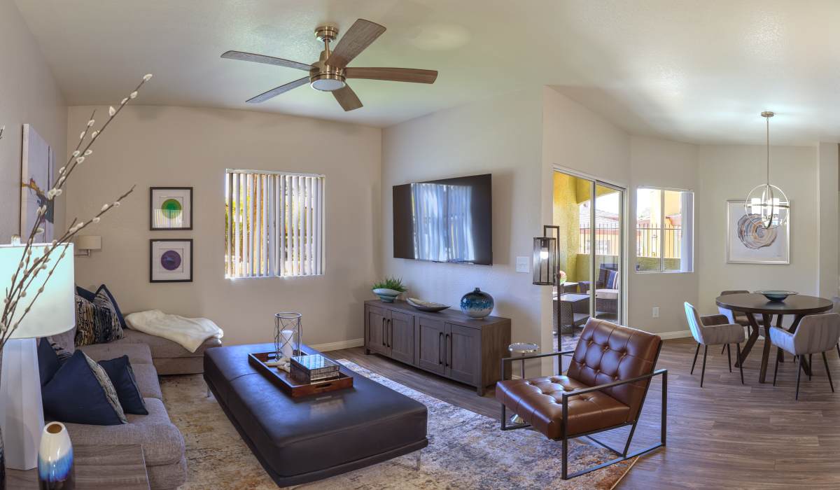 Large living room with a ceiling fan at La Serena at the Heights in Henderson, Nevada