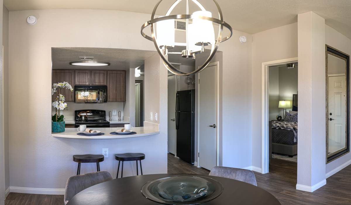 Model dining room with a view of the kitchen at La Serena at the Heights in Henderson, Nevada