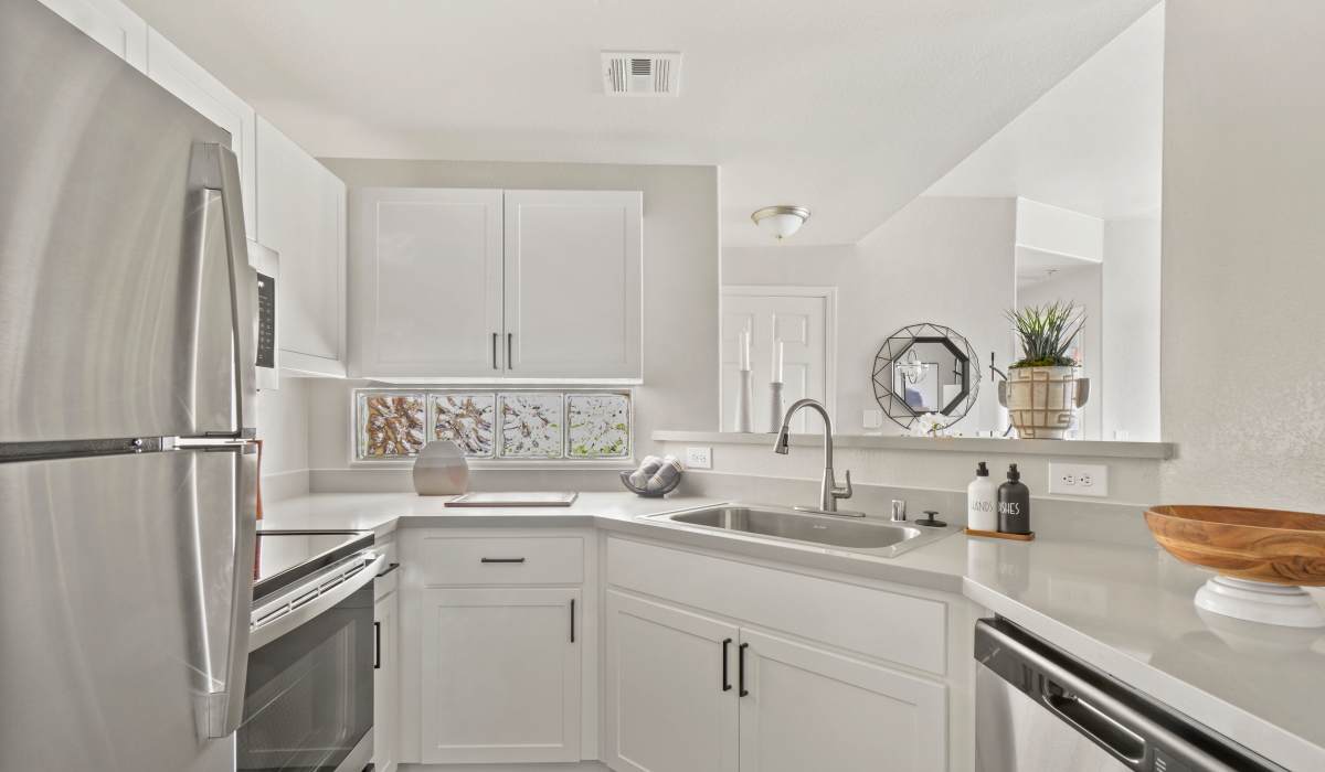 Modern kitchen with white counters at La Serena at Toscana in Phoenix, Arizona